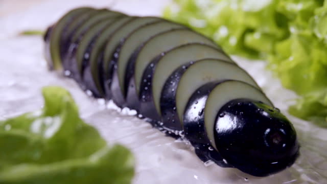 Falling-of-sliced-eggplant-into-the-wet-table.-Slow-motion-240-fps