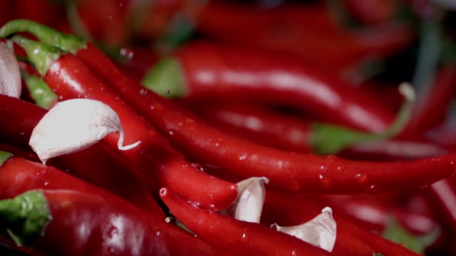 Falling-of-garlic-into-the-red-hot-pepper.-Slow-motion-480-fps