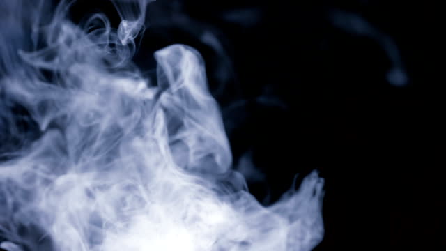 A-lot-of-white-smoke-isolated-on-black-background-slow-motion-up