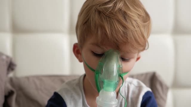 Boy-makes-inhalation.-medical-equipment