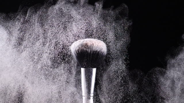two-make-up-brushes-collide-creating-an-explosion-of-colored-powder-5
