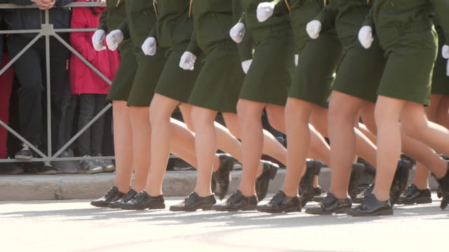 Military-women-march-in-parade-in-green-uniform-in-slowmotion-in-the-town-square