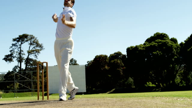Jugador-de-bolos-entrega-de-balón-y-atractivo-durante-el-partido-de-cricket