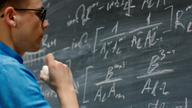 Brilliant-Young-Mathematician-Writes-Complex-Math-Equation/-Formula-on-the-Blackboard.
