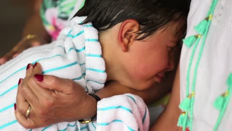 Crying-child-being-consoled-by-grand-mother-arms.-Young-boy-crying-and-weeping-in-grandma-affection.-Kid-cries