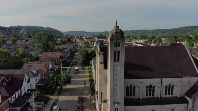 Slow-Lowering-Aerial-Establishing-Shot-of-Small-Town-and-Church