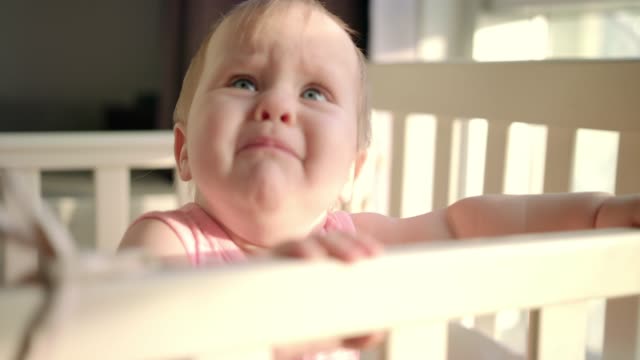 Sad-baby-crying-in-cot-at-home.-Unhappy-toddler-standing-in-crib