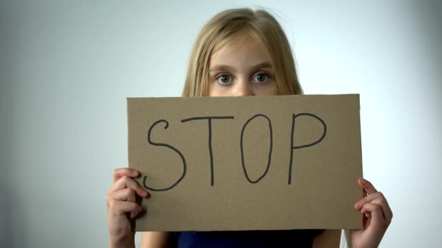 Mädchen-zeigt-Stop-Schild,-sozialen-Schutz-der-Kinder-häusliche-Gewalt-Prävention