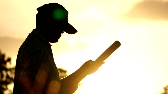 Men-are-hitting-the-baseball-player-with-the-sunset