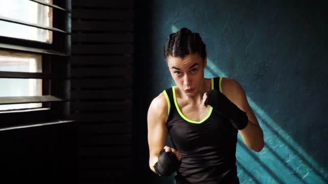 Mujer-Boxeo-joven-hermoso-Fit-formación-perforando-en-fitness-studio-lenta