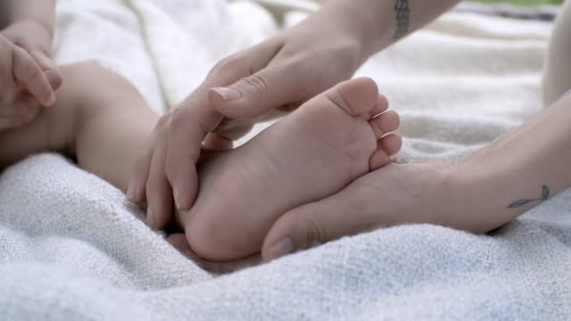 Mother-Touching-Foot-of-Baby