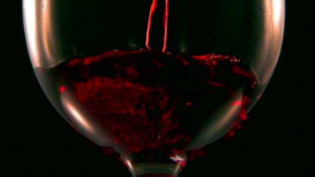 Extreme-close-up-of-red-wine-into-glass