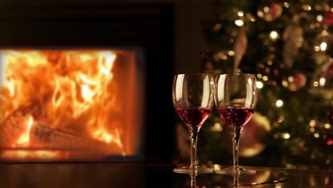 Two-glasses-of-red-wine-by-fireplace.-Cozy-romantic-evening-near-the-fireplace.-4K