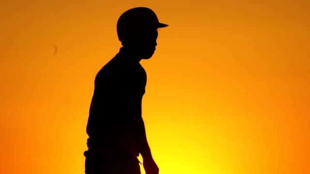 Silhouette-man-with-a-baseball-glove-catching-a-baseball