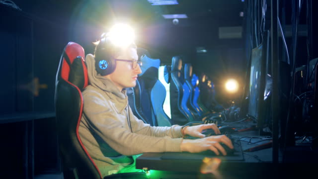 Young-man-in-glasses-and-headphones-is-playing-a-computer-game
