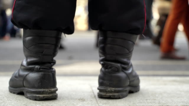 Concept-power-and-people,-police-and-demonstrators.-Demonstrators-through-police-boots