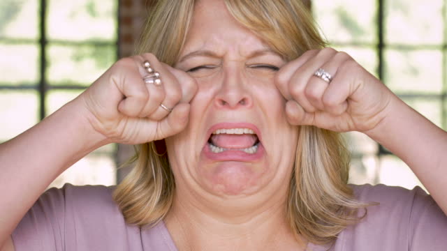 Unhappy-woman-crying-and-wiping-her-face-with-her-hands---waa-waah