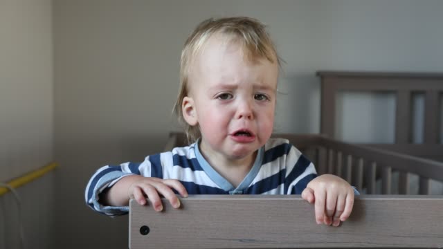 Crying-baby-boy-in-crib-at-home