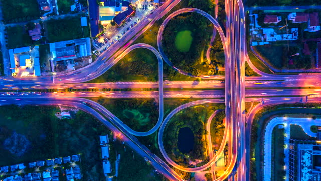 Aerial-view-Time-lapse-of-the-expressway,-motorway-and-highway-in-the-detail-of-intersection-at-night