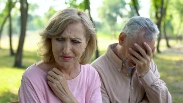 Elderly-couple-crying,-frustrated-with-illness-of-close-relative,-despair