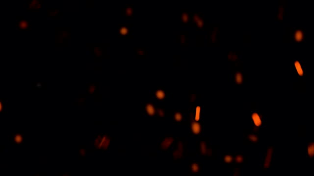 high-speed-shot-of-fire-flames-and-glowing-ash-particles-on-black-background