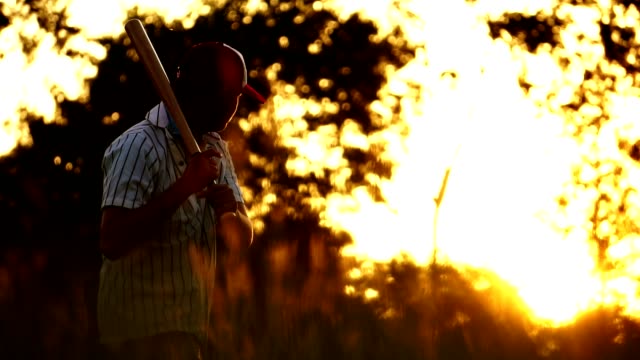 Men's-baseball-practice-hitting-a-baseball-with-the-light-of-sunset