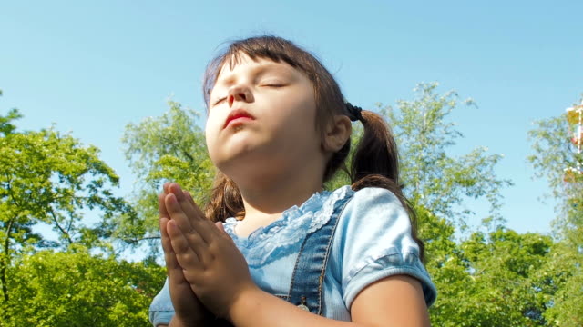 The-child-prays-in-nature.