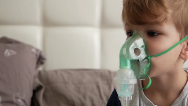 Boy-makes-inhalation.-medical-equipment