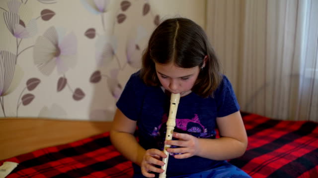 Girl-Practicing-Flute-at-Home