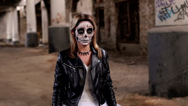 The-girl-in-a-wedding-dress-and-in-jacket-with-a-make-up-in-form-of-a-skull.
