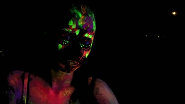 Sitting-beautiful-sexy-girl-with-ultraviolet-paint-on-her-face-and-body.-Girl-with-color-neon-bodyart