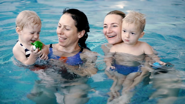 Swimming-pool.-Moms-teach-young-children-to-swim.