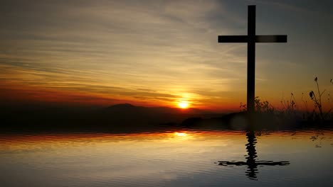 Cruz-de-Jesucristo,-cerca-del-agua-con-la-puesta-de-sol-y-estado-de-ánimo-tranquilo.