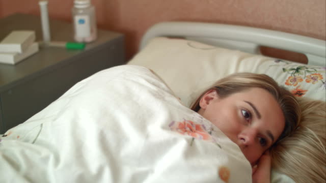 Female-patient-wakes-up-in-a-hospital-bed