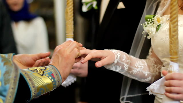 Pastor-of-Orthodox-Church-holding-wedding-ceremony-for-religious-newlyweds