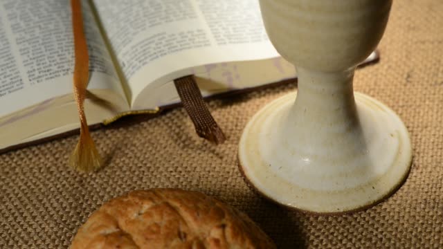 bible-with-chalice-and-bread,-panning,sliding,-tilt