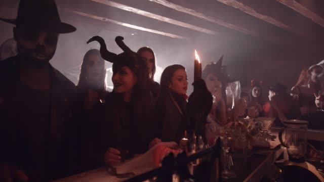 Man-and-woman-drinking-and-flirting-at-bar-at-Halloween