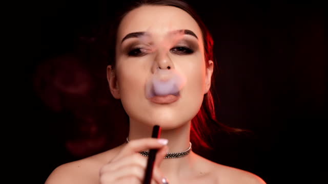 Glamourous-gorgeous-brunette-woman-smoking-electronic-cigarette