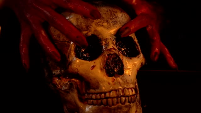 Woman-with-blood-hands-holding-skull