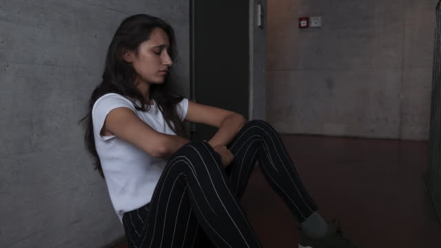 Sad-Girl-Sitting-on-Building-Floor