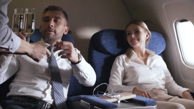 Businesspeople-Drinking-Champagne-on-Plane