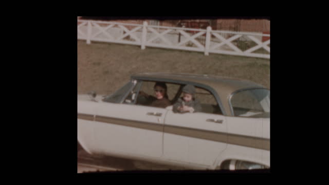 1959-Little-boy-shoots-cap-gun-from-vintage-car-1957-Plymouth-Belvedere