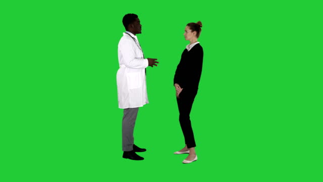 Male-african-doctor-talking-to-female-patient-on-a-Green-Screen,-Chroma-Key