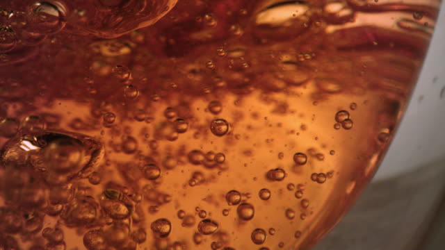 Extreme-close-up-of-air-bubbles-inside-tea-glass