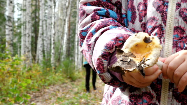 Mom-teaches-her-little-daughter-to-pick-mushrooms.