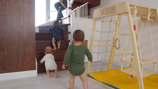Toddler-Triplets-Climbing-up-Staircase-towards-Mom