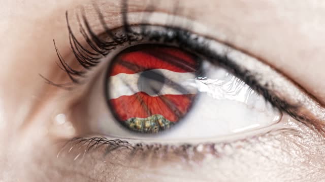 woman-green-eye-in-close-up-with-the-flag-of-Austria-in-iris-with-wind-motion.-video-concept