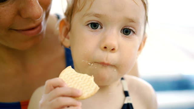 The-child-eats-cookies.-The-child-after-eating-in-the-pool-eats-cookies.