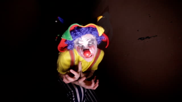 A-scary-clown-in-a-dark-alley-makes-faces.