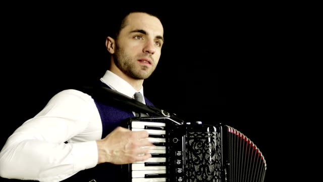 Close-up.-A-musician-in-a-white-shirt-plays-the-accordion.